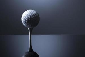 Golf ball over tee isolated on dark blue reflective background. photo