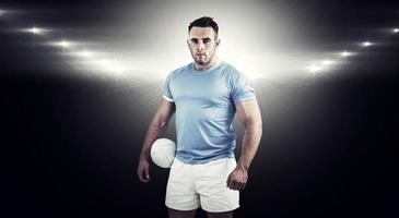 Composite image of rugby player looking at camera photo