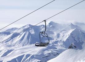 Chair lifts and off-piste slope in fog photo
