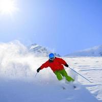 Freeride in fresh powder snow - man skiing downhi