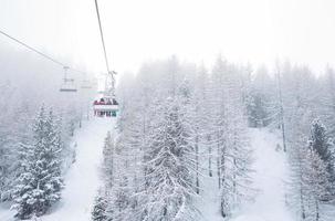 Ski lift with passengers in the gondola photo