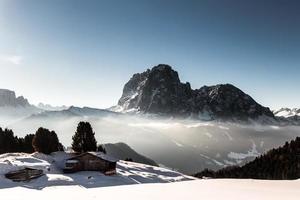 alpine hut in a winter day photo