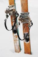 old wooden skis in the snow photo