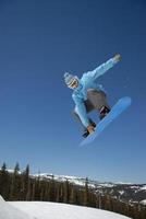 Snowboarder big air over a jump in Colorado photo