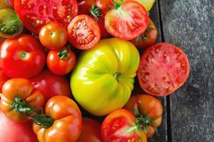 assorted tomatoes on wooden surface photo