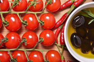 cherry tomatoes, peppers and black olives photo