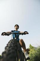 young woman training on mountain bike and cycling in park photo