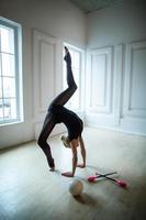 Flexible gymnast doing exercise photo