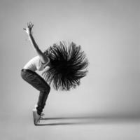 beautiful dancer girl squatting with flying hair photo