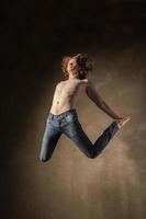 Young and stylish modern dancer on grey background photo