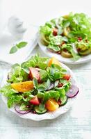 Colorful tomato salad with pomegranate seeds photo