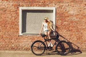 beautiful young woman with bike outdoors