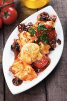 Tortellini pasta with tomato and olive sauce