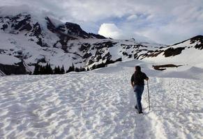 Young Man Hiking in Snow at Mt. Ranier National Park photo