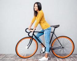 Smiling woman with bicycle photo
