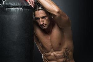 MMA Fighter Practicing With Boxing Bag photo