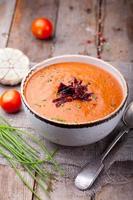 Tomato soup with sun dried tomatoes. Wooden background