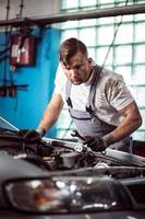 Car mechanic with wrench photo