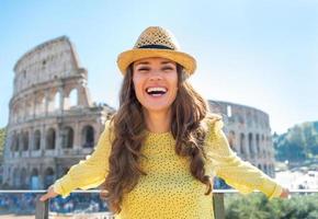 Young woman in front of colosseum, italy