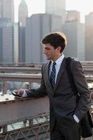 Young businessman text messaging photo