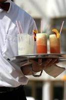 Waiter with fruit cocktails