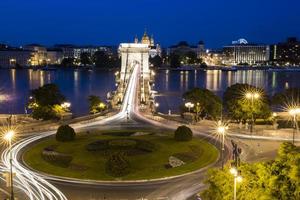 roundabout with light streaks, bridge and tiber photo