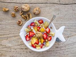 Bowl of fruit, walnuts and yogurt