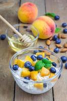 Fresh cottage cheese with peach, blueberry, almonds and honey