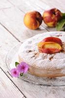 Cake with peach wooden table close up photo