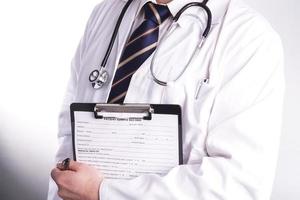 Male doctor ready to write patient information