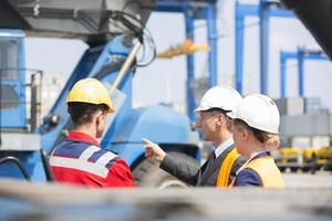 Workers discussing in shipping yard photo