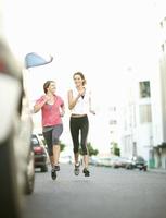 Smiling women jogging together