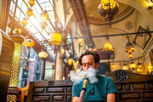 Man smoking turkish hookah photo