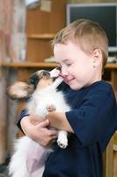Puppy licking childs face