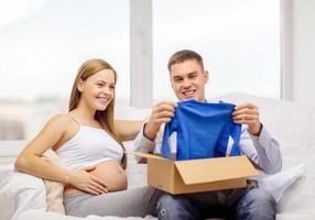 happy family expecting child opening parcel box photo
