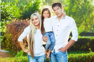 Happy family with child outdoors in jeans photo