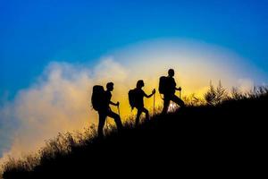 Three people family silhouettes on vacation photo