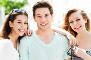 Young man with two female friends photo