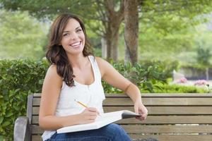 Young Adult Female Student on Bench Outdoors