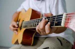 Female hand playing music by acoustic guitar photo
