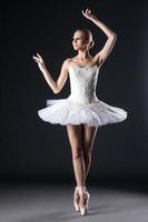 Attractive female ballet dancer posing in studio photo