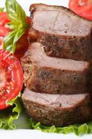 slices of roasted duck meat fillets with tomatoes vertical