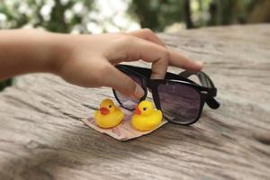 yellow rubber duck and black sunglasses