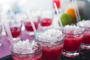 Line of different alcohol cocktails on event open-air night party