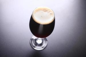 Glass of dark beer photo