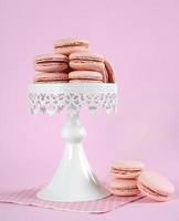 Pink macarons on white vintage style cake stand