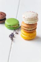 Macarons on white wooden background photo