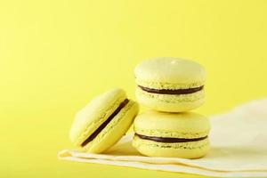French macarons on yellow background photo