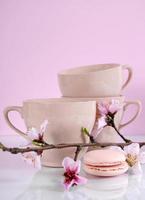 Pink macaron cookies with vintage cups photo