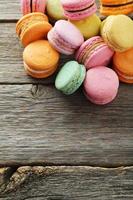 French colorful macarons on grey wooden background